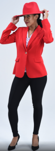 Woman with brown skin and curly hair in a ponytail standing in a red hat, red blazer, black pants, and black heels